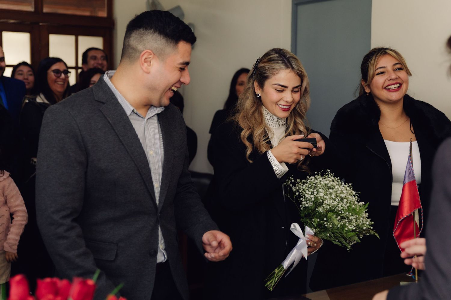Smiling bride holding white flower bouquet walking with groom at civil wedding.