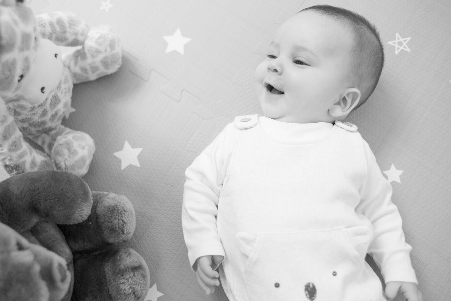A black and white photo collage showing a baby's expressions and movements in different moments.