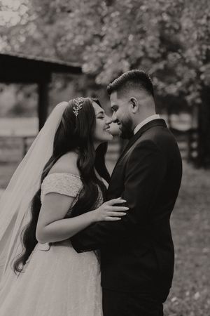 A romantic wedding photo sequence showing a couple in an intimate embrace under blooming trees.