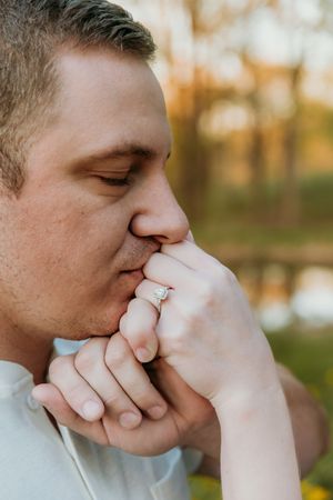 Close-up shots of hands with engagement ring in autumn lighting.