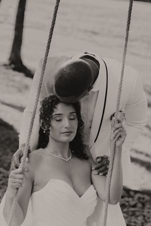 Vintage black and white portrait series of a bride on a swing in classic 1920s style.