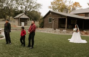 A collection of outdoor wedding photos showing guests and wedding party members on a grassy lawn near rustic buildings.