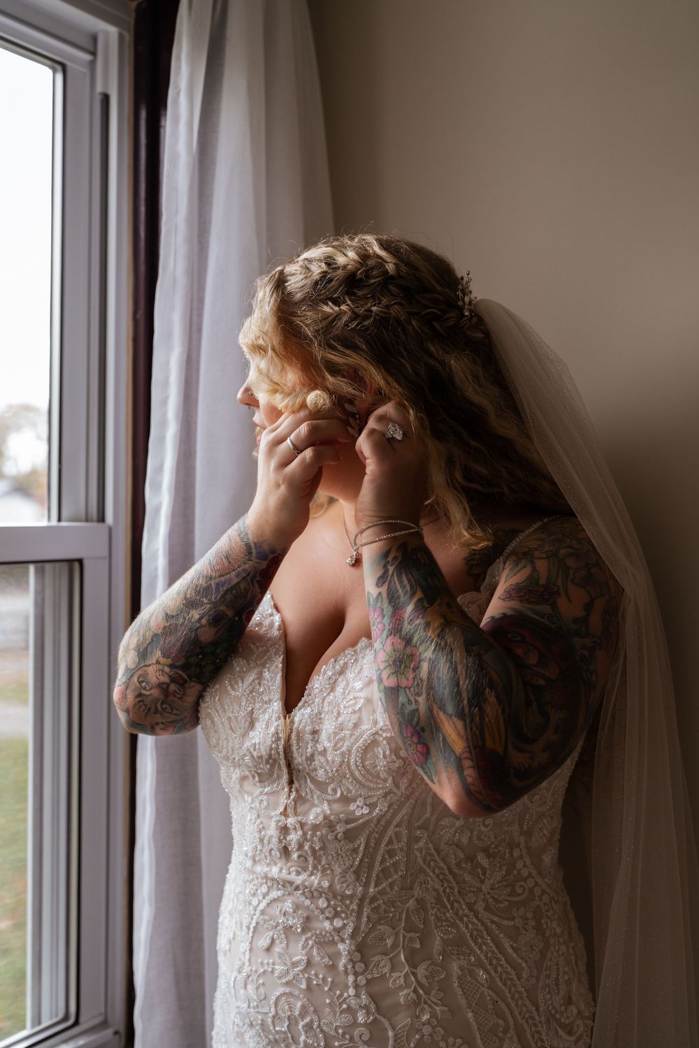 Artistic sequence of bridal portraits by window showing flowing lace dress and veil.
