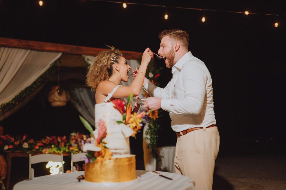 Wedding reception dance floor with string lights and tropical decor at night.