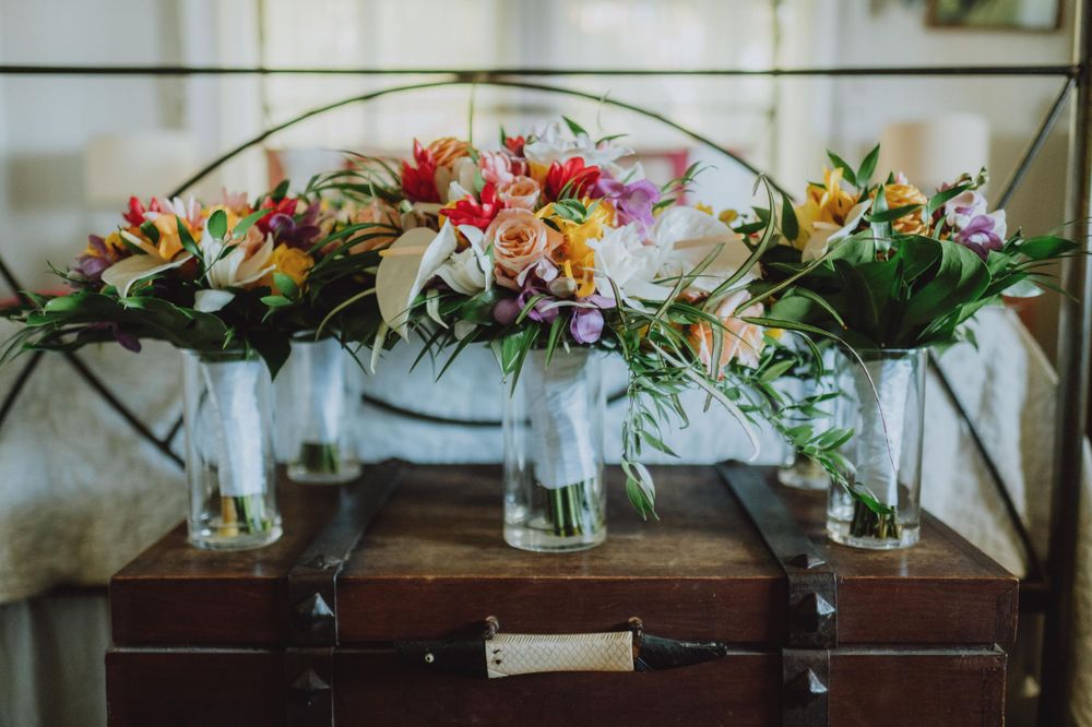 Elegant floral arrangements with pink and white blooms displayed at a wedding venue.