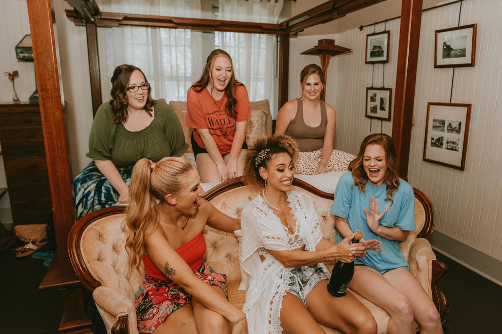 Friends sharing joyful moments and laughter while relaxing on indoor seating.