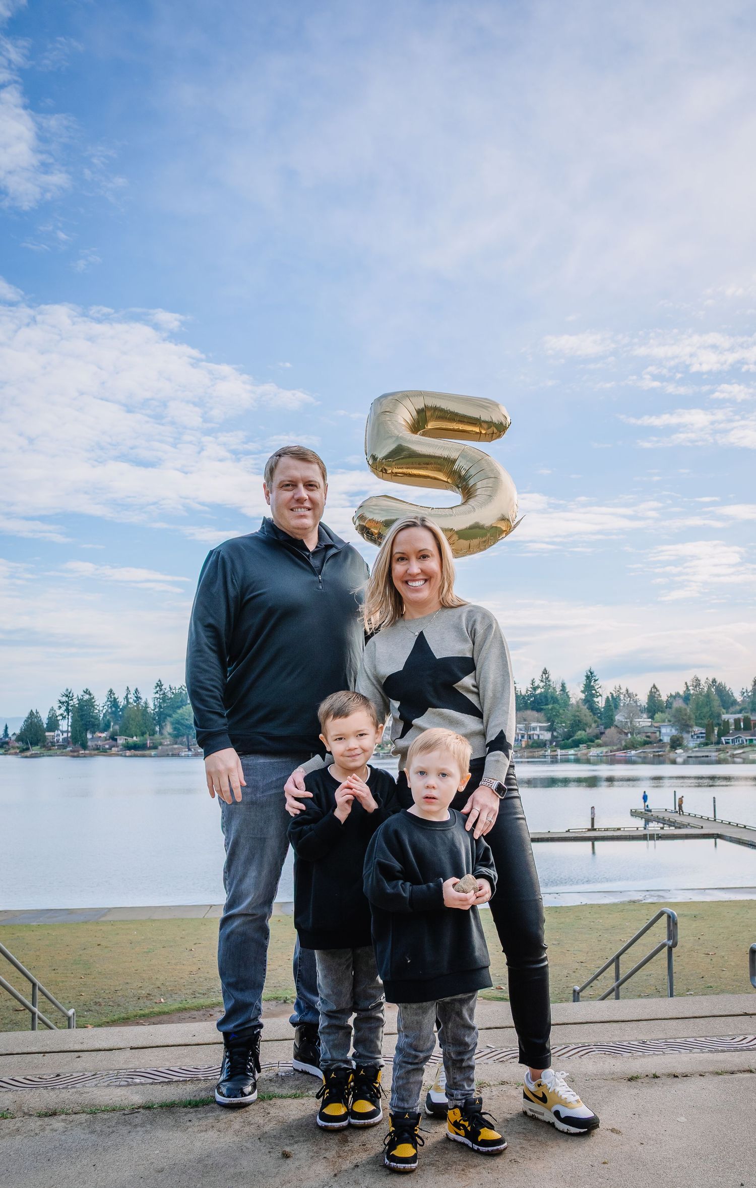Parents posing with their children during an outdoor family photo session in SeaTac
