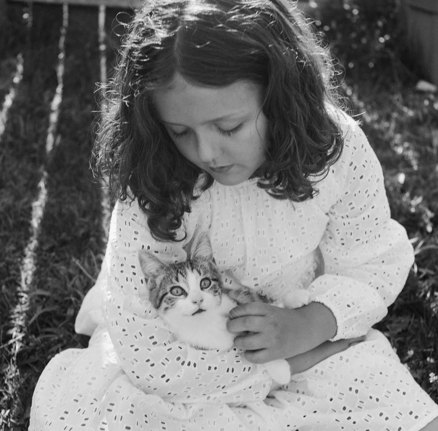 A series of vintage-style photographs showing someone in a white lace dress reclining among garden flowers.