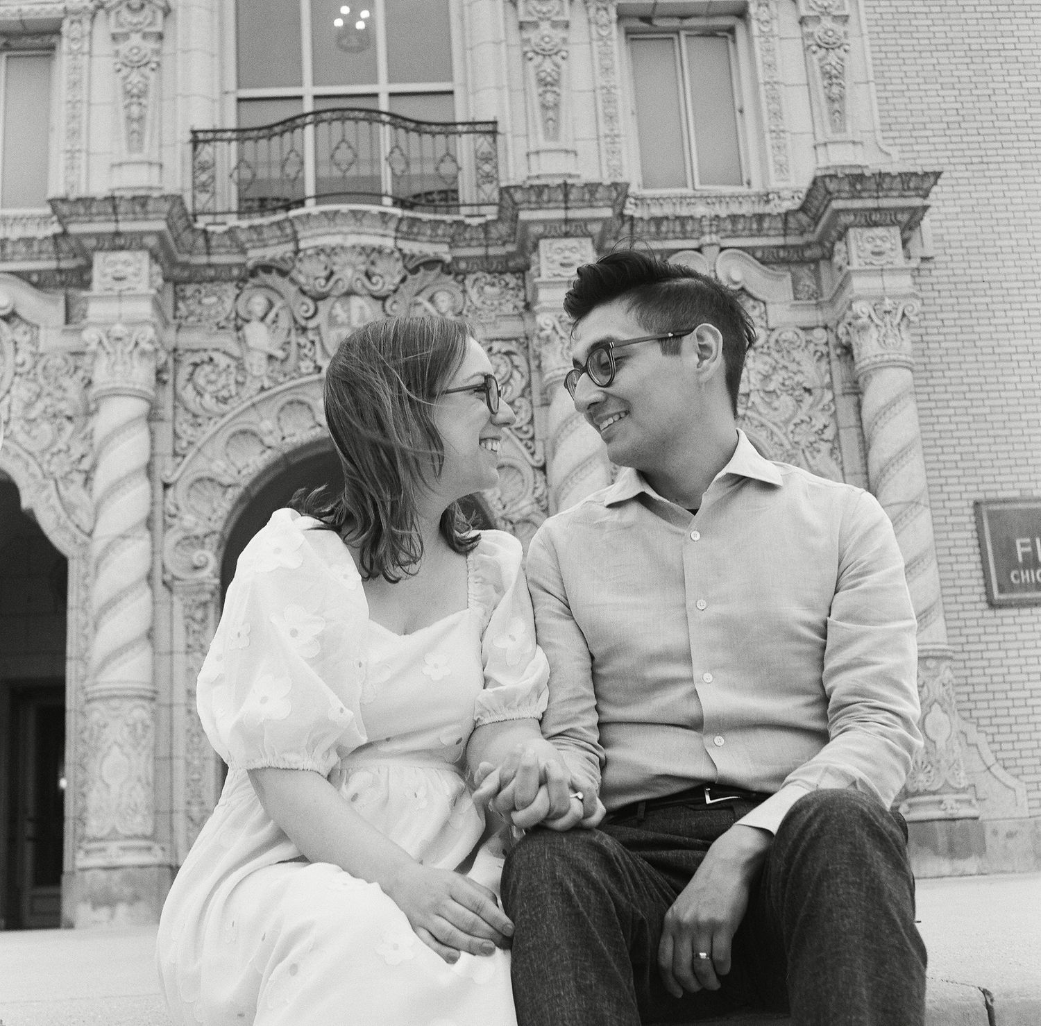 A black and white photo montage showing four candid moments of a couple sitting and interacting on a bench.