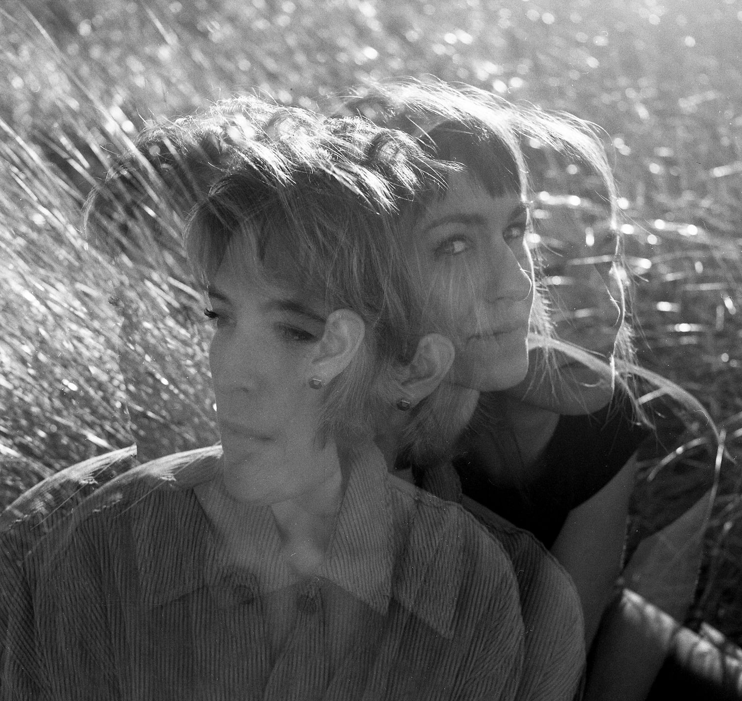 Black and white photo sequence showing two figures in an intimate moment against a blurred outdoor background.