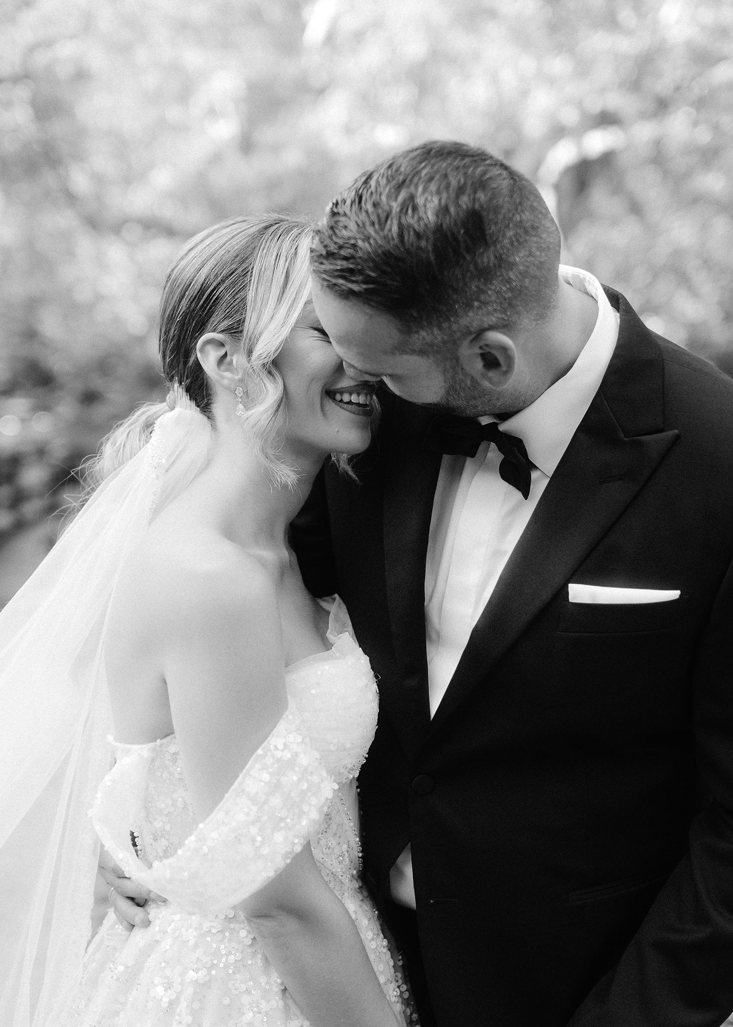 A romantic black and white wedding photo collage showing tender moments between a couple in formal attire.