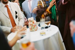 People enjoying drinks and conversation at an elegant social gathering or cocktail party.