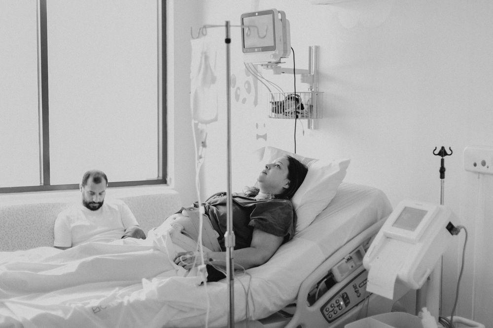 Hospital bed with medical monitoring equipment in a clinical setting.