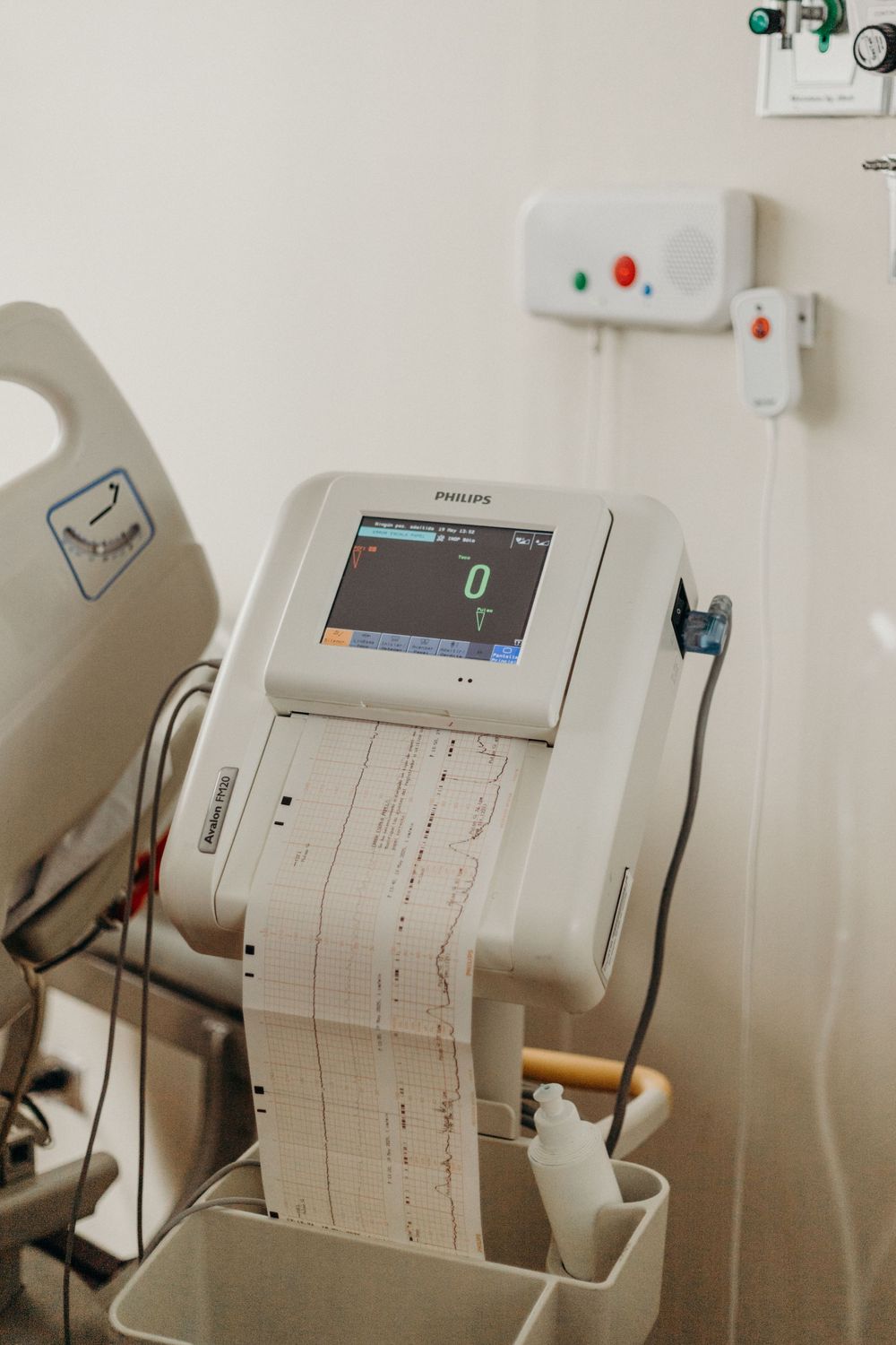 Medical monitoring equipment displays vital signs and data readouts on multiple screens.