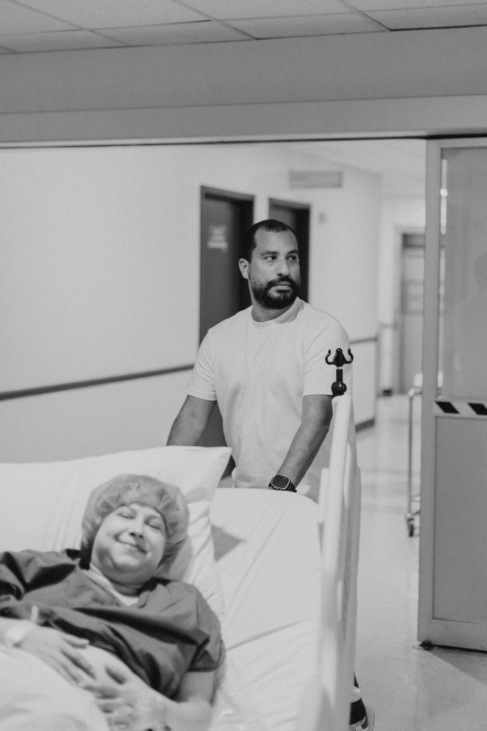 A healthcare provider tends to a patient in a hospital room with medical equipment.