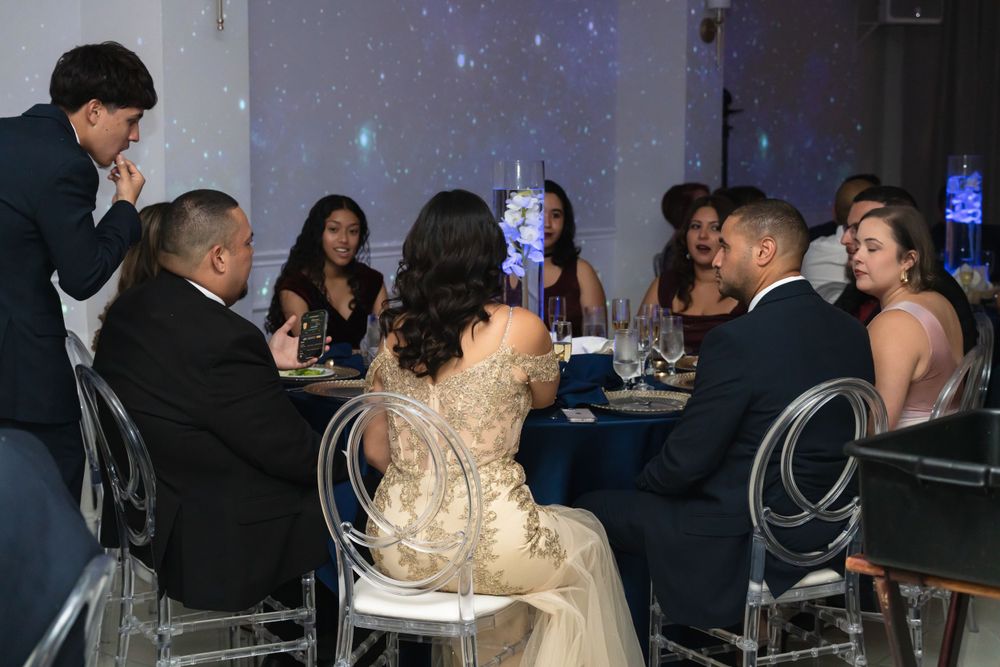 Guests seated at an elegantly decorated table during a formal celebration.