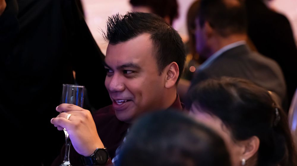 A group enjoying drinks at an elegant evening event.