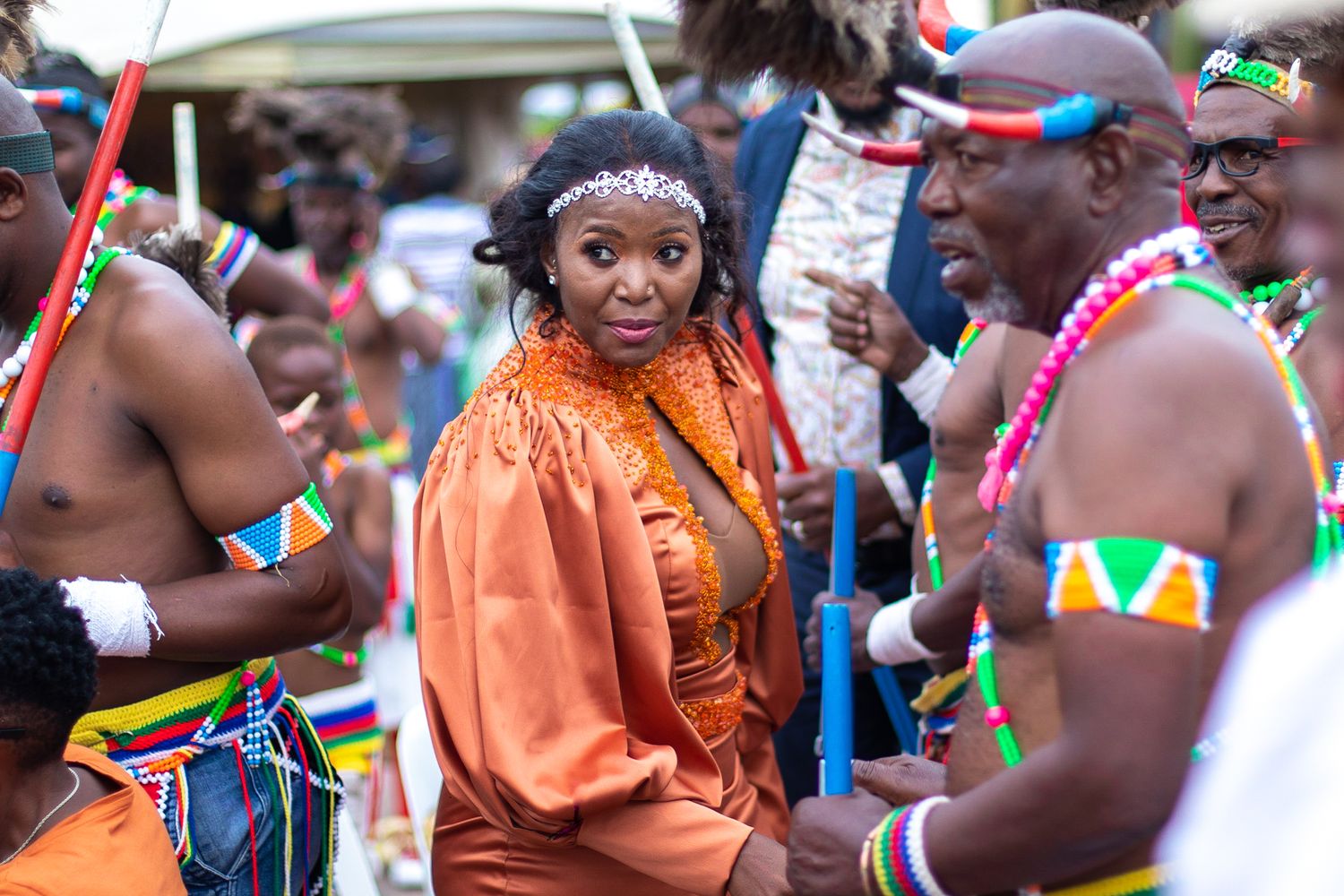Attendees in traditional African attire gather at a cultural celebration.