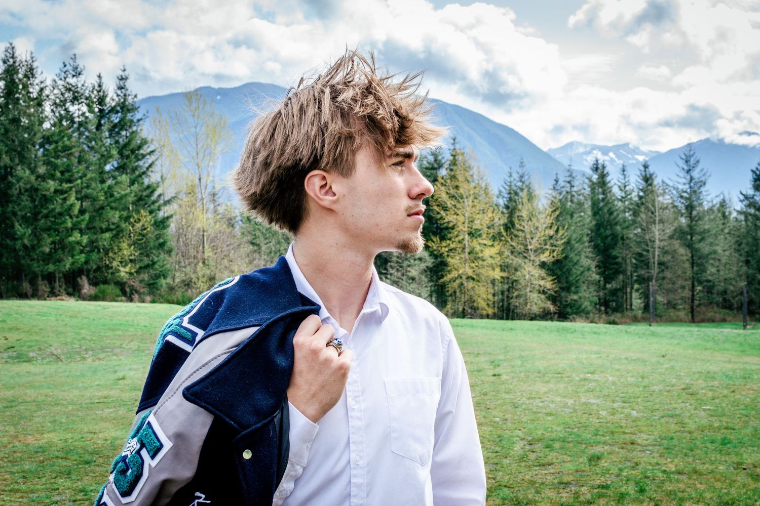 Senior looking toward mountains at Snoqualmie Point Park with scenic Washington views an hour away from Seattle.