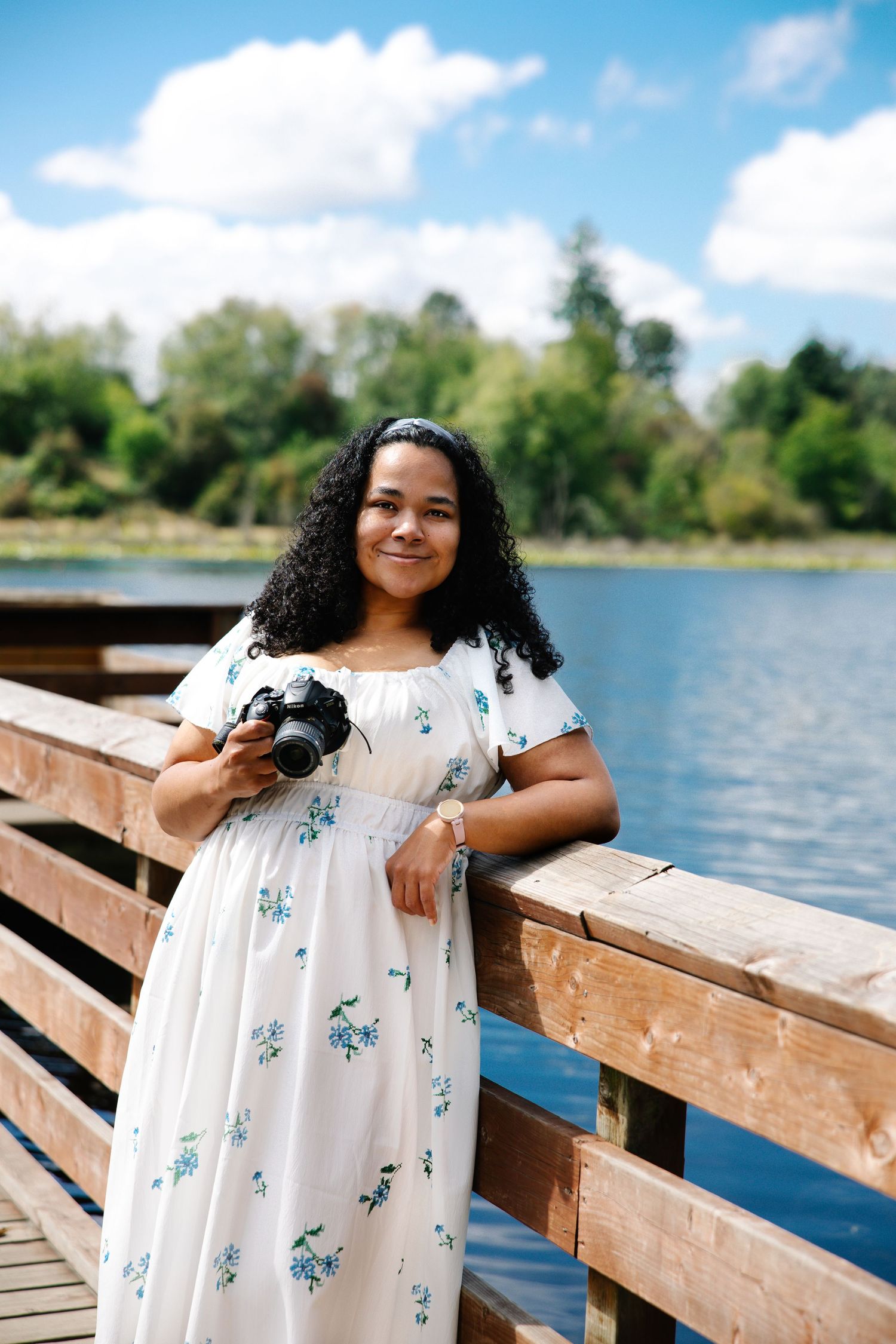 Brand photo of photographer on a bridge with soft natural light—relaxed and welcoming personal brand image for website or social media.