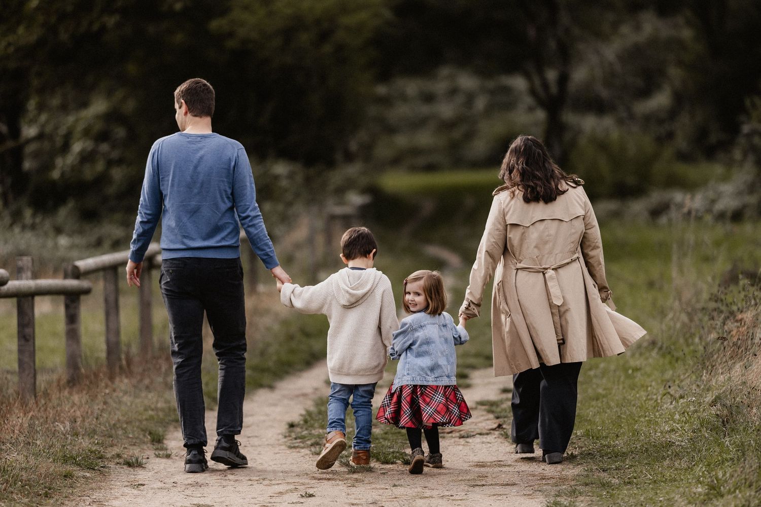 Family enjoying a playful moment together in a park setting.