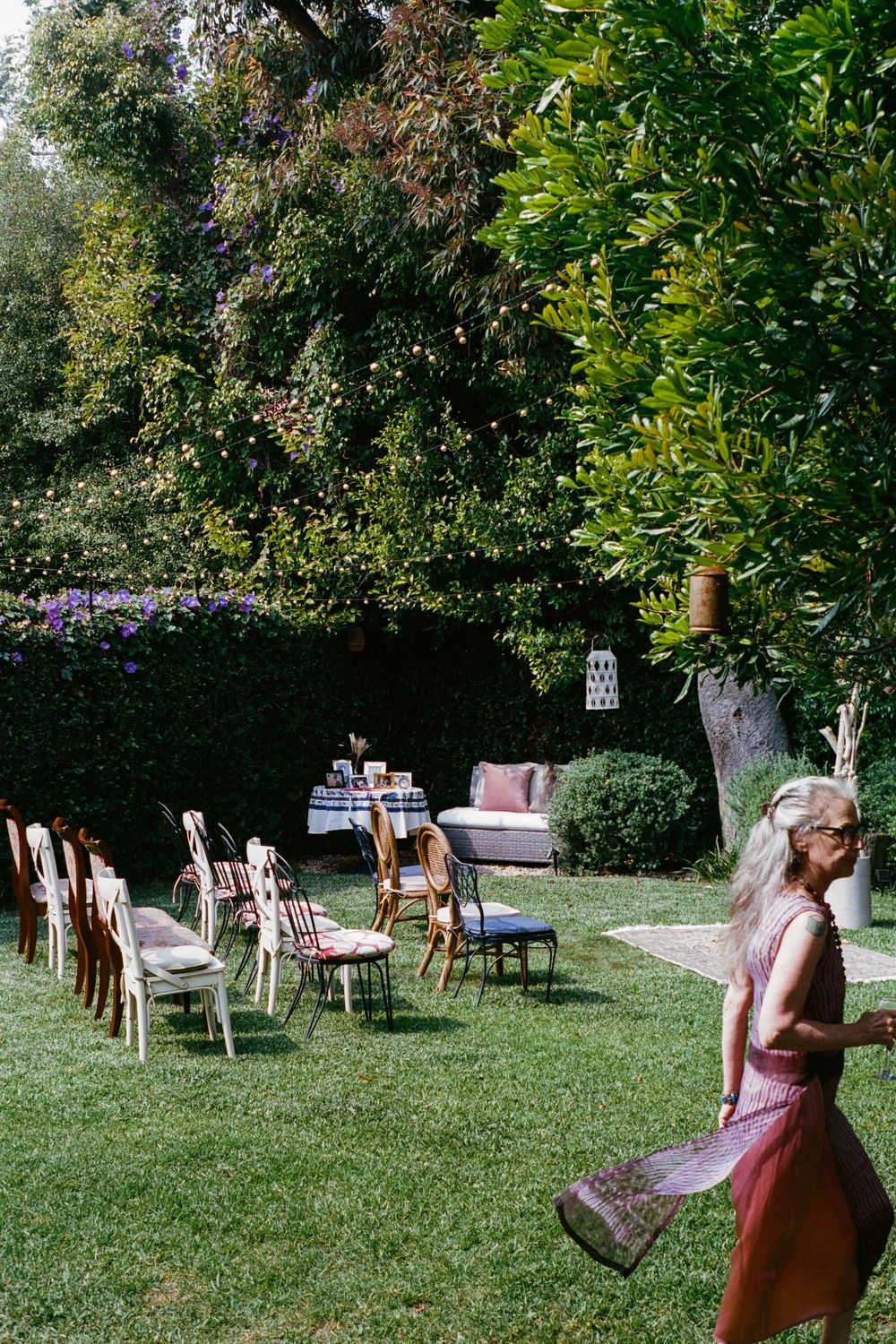 Vintage furniture and seating arrangements scattered across a garden lawn.