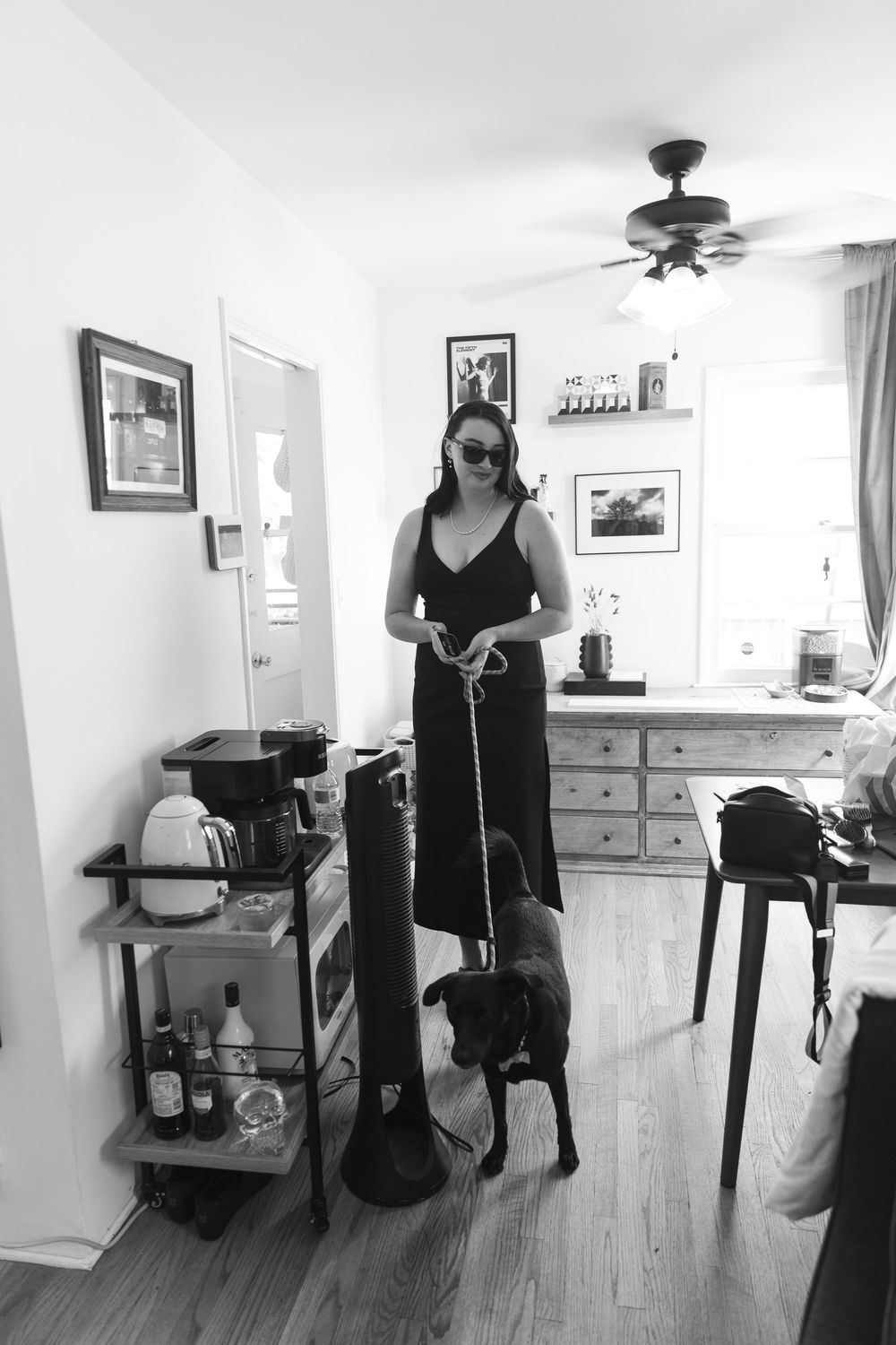 A series of black and white images showing someone with a walking stick in a home interior.