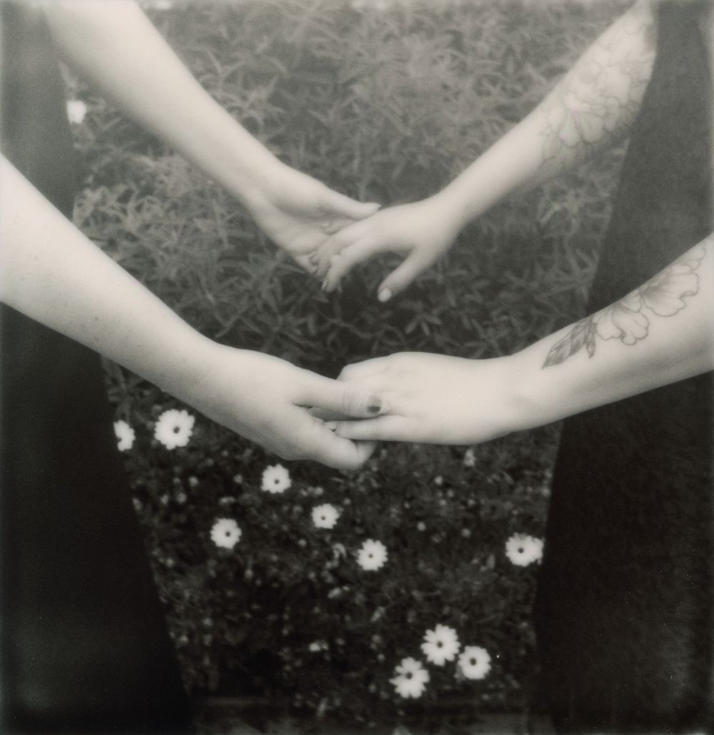 Black and white artistic photo series showing hands and flowers.