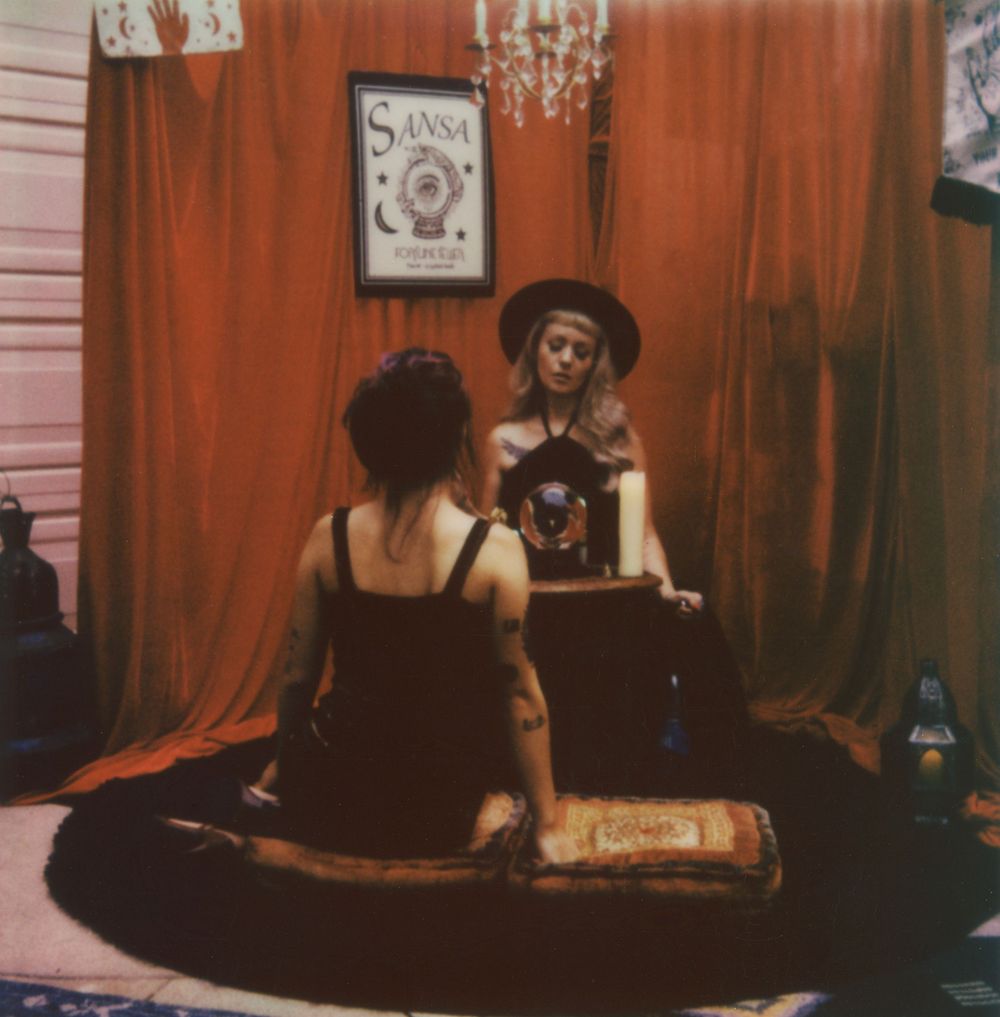 A series of dimly lit indoor photos with red curtains and vintage decor.
