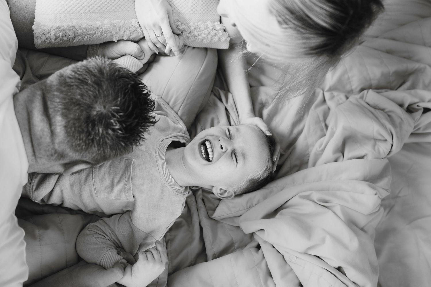 Black and white family portrait capturing intimate parent and child moment