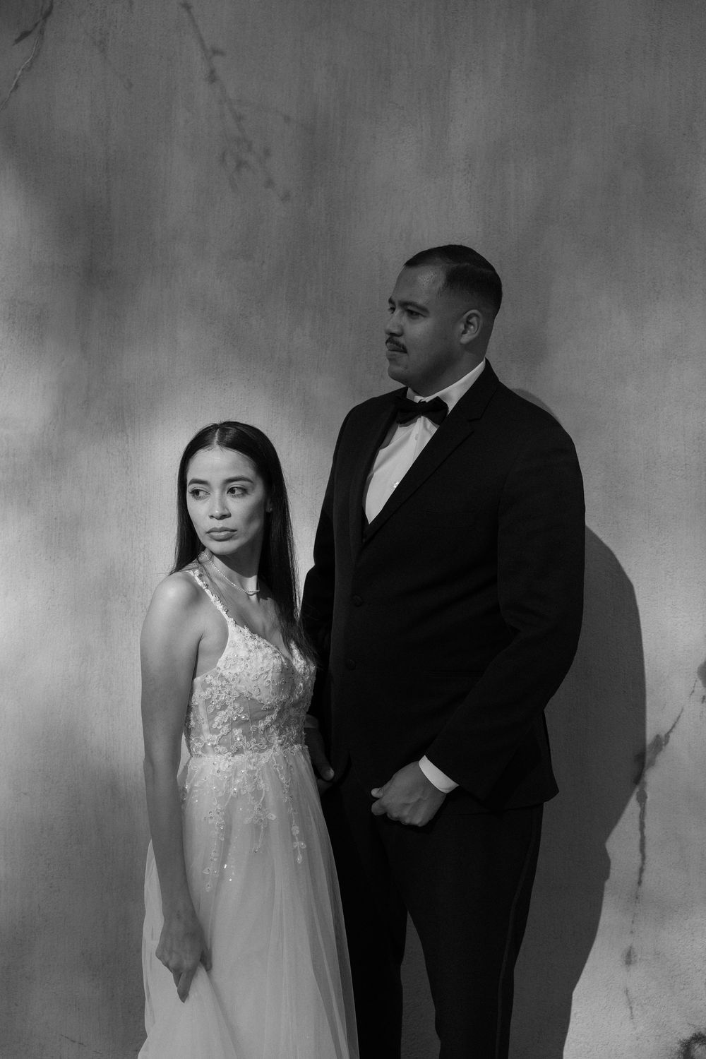 A black and white portrait of a couple in formal attire on the steps of the Swan House in Atlanta, GA.