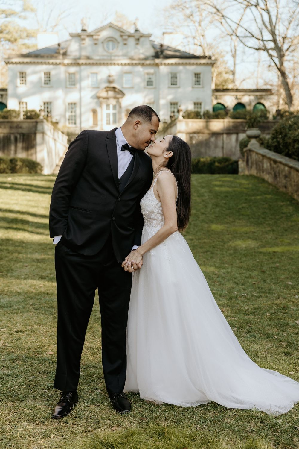 A wedding couple poses together on the grounds of the Swan House in Atlanta, GA.