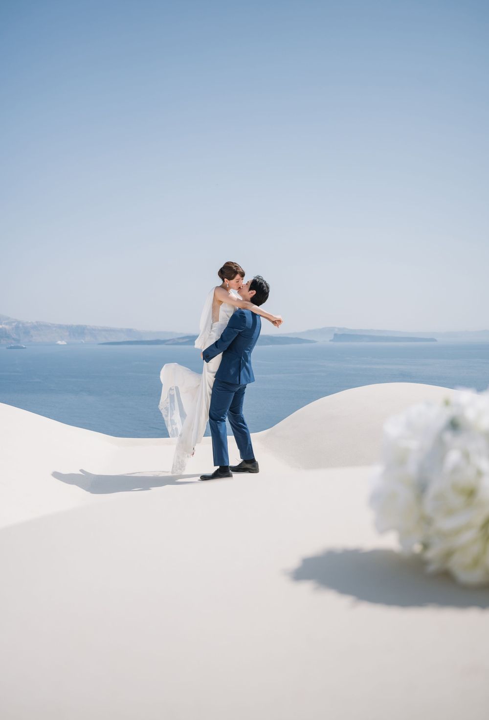 A romantic dance on white painted terraces overlooking the blue Mediterranean Sea.