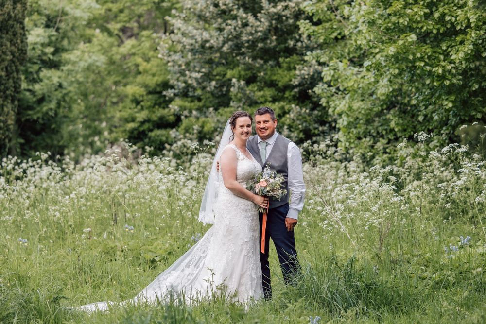 Wedding couple in wild flowers at Gildredge Manor gardens