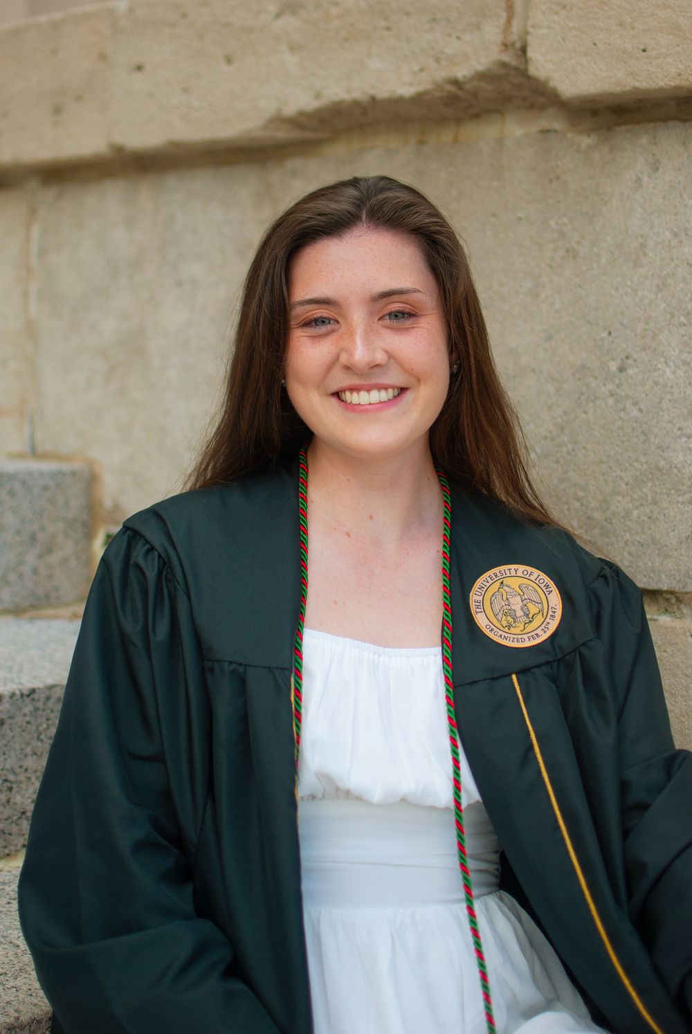 A portrait of a woman wearing a graduation gown