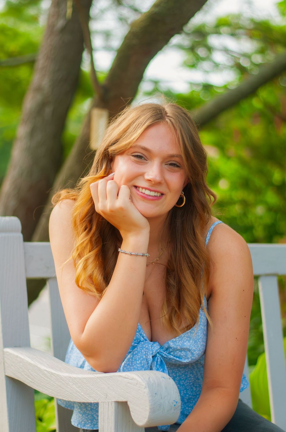 Portrait of a young woman sitting on a bench
