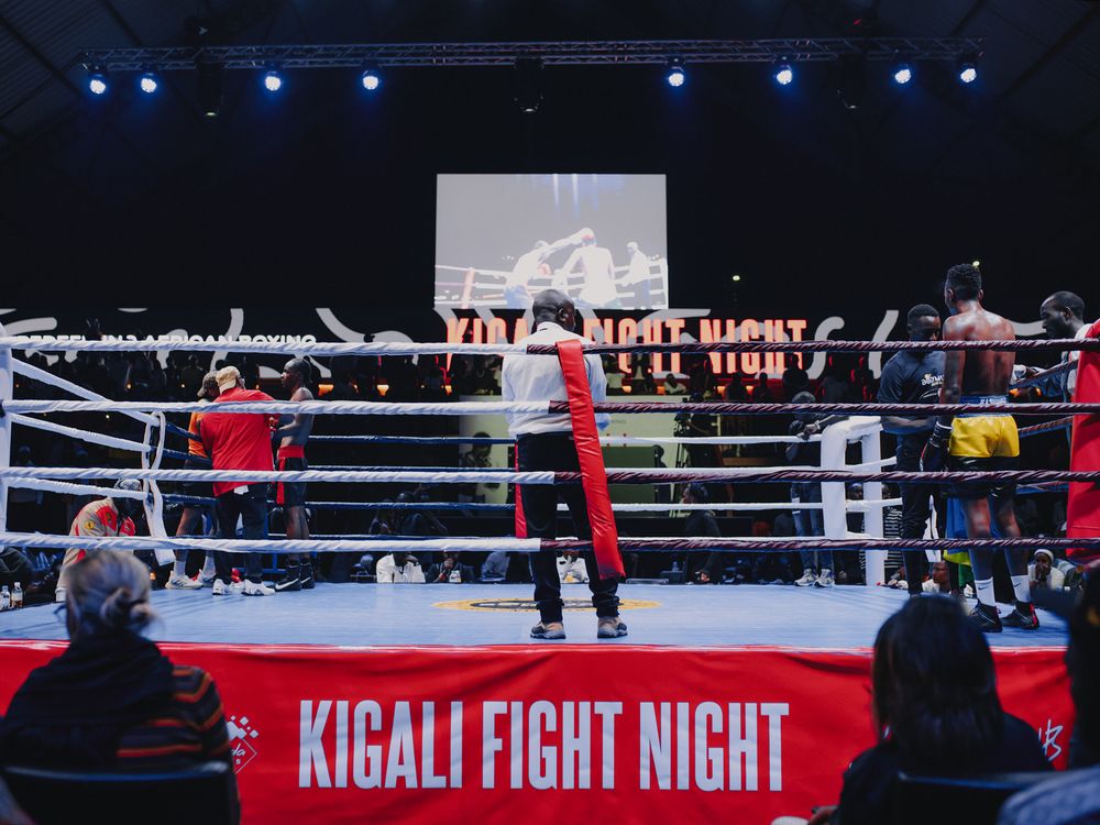Professional boxing match at Kigali Fight Night with boxers competing in a well-lit ring.
