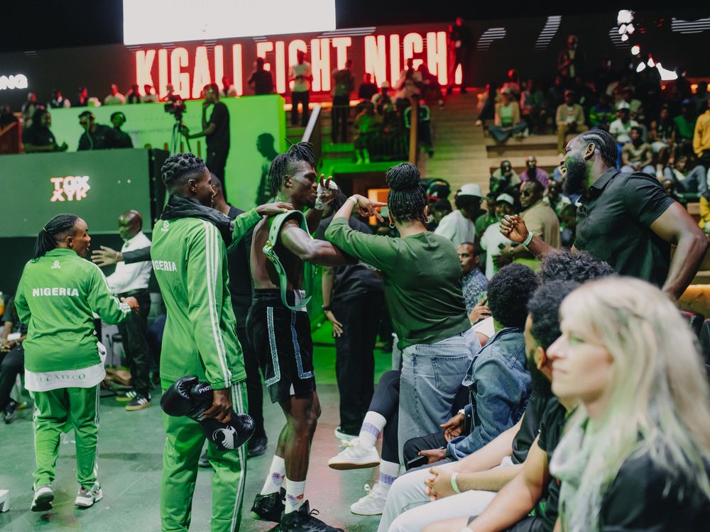 Spectators gather at a green-themed sports event with dynamic lighting and crowd energy.