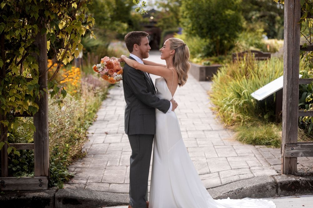 A romantic wedding ceremony sequence on a stone pathway surrounded by lush greenery.