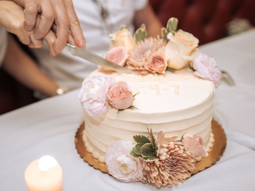 A series of wedding cake photos showing delicate pink roses and white frosting details at different angles.