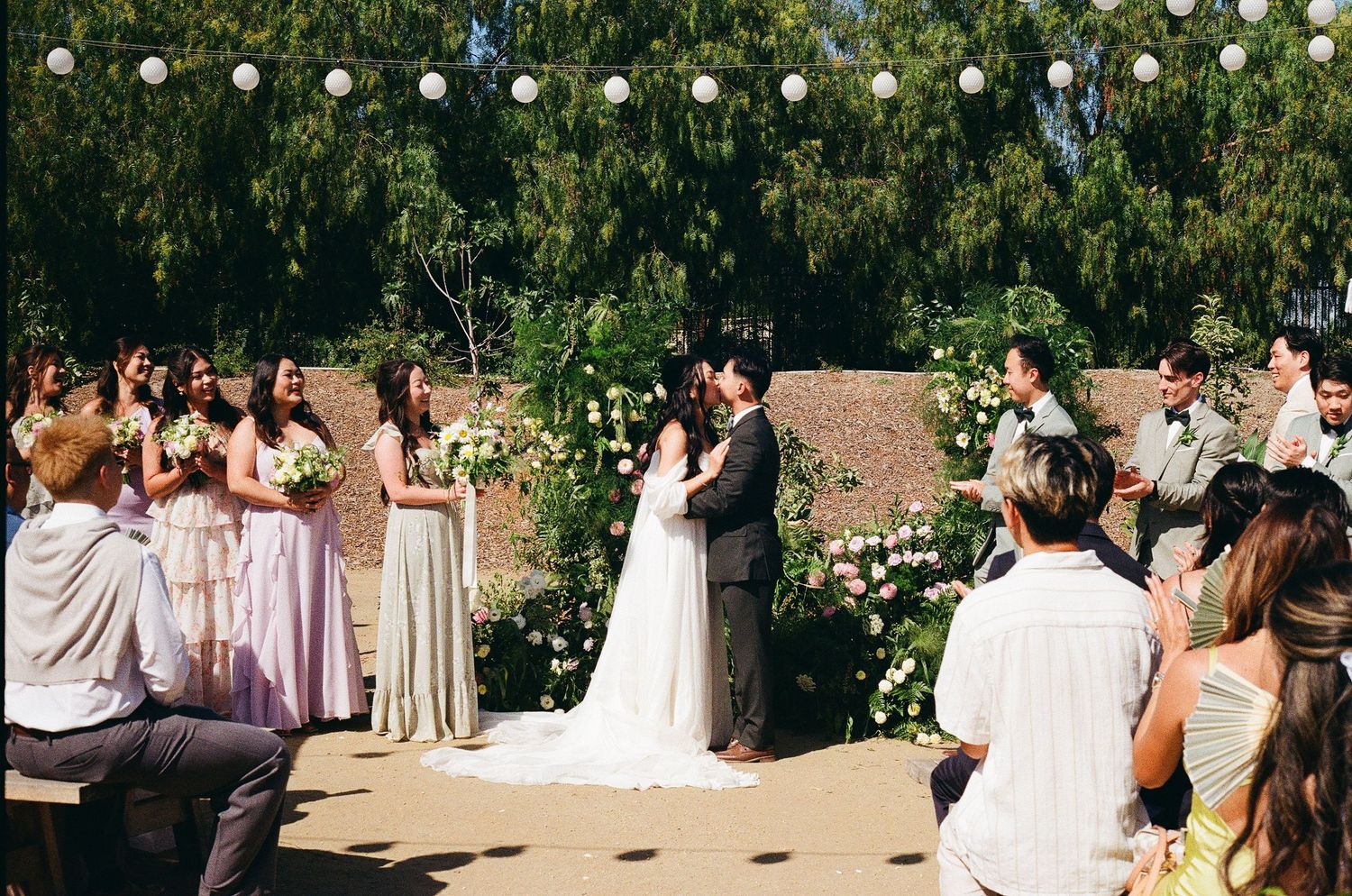 Emotional first kiss captured on 35mm film by a Santa Barbara wedding photographer at the altar.