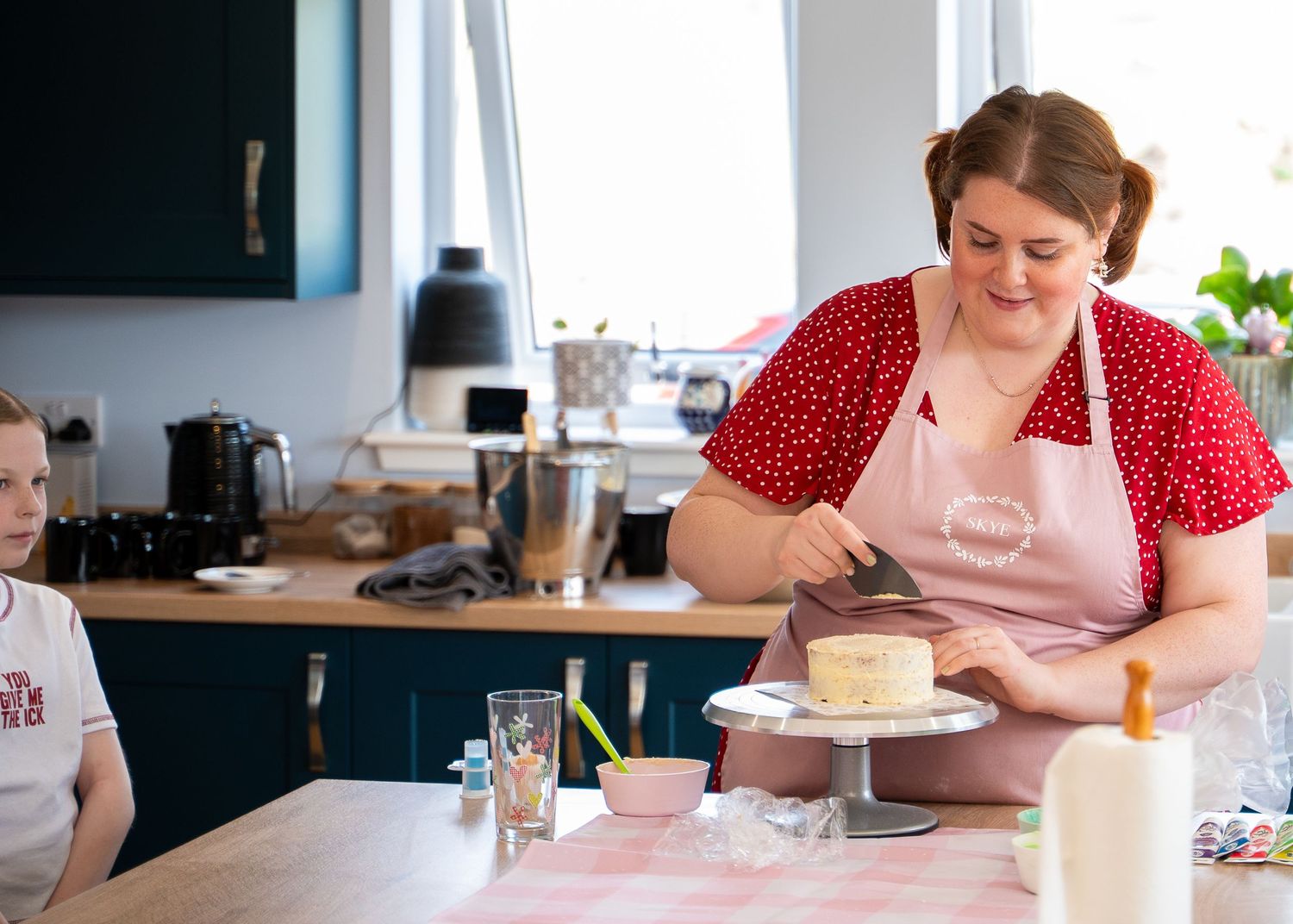Someone in a red polka dot dress sits at a table with a white candle and glass of water. Business branding in Scotland.