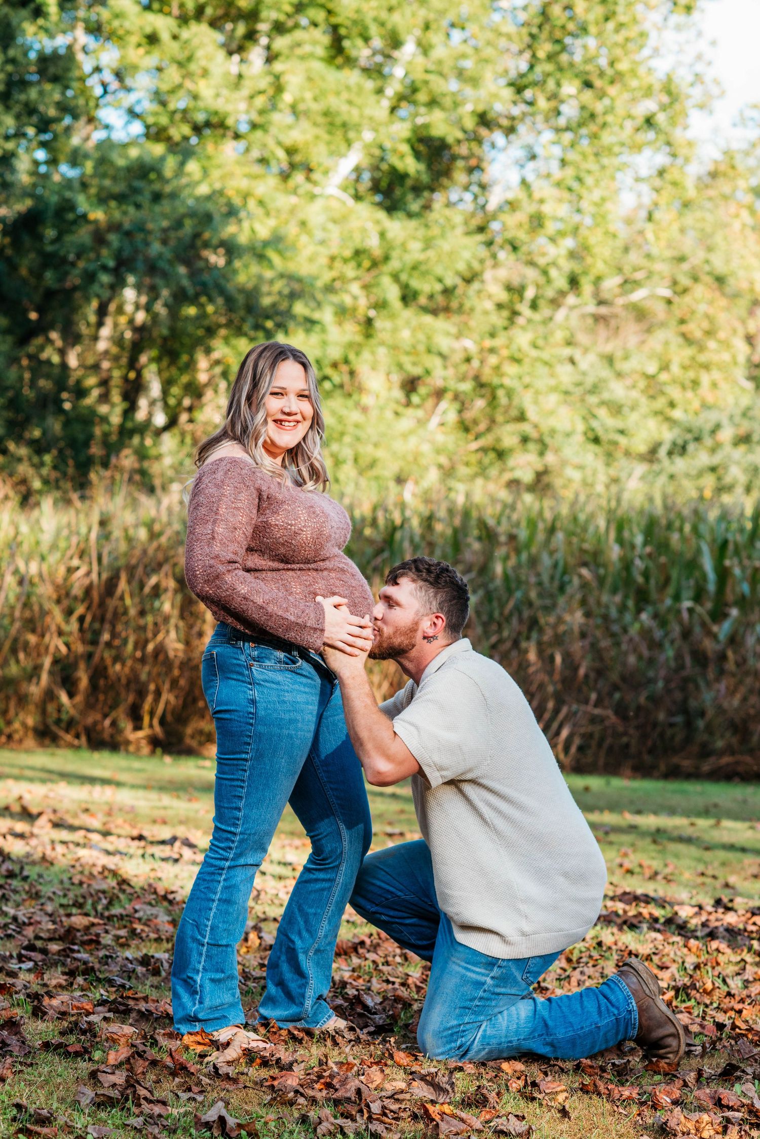 Candid engagement photos showing a couple sharing a joyful moment outdoors during autumn.