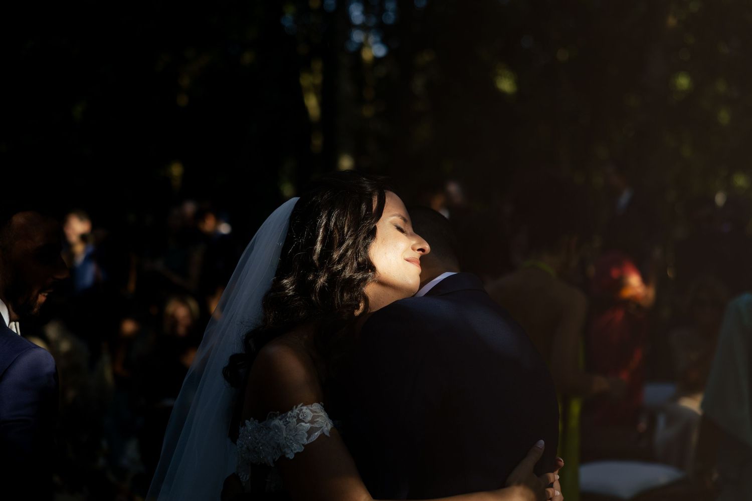 Candid reception moments captured in evening light with bokeh effects.