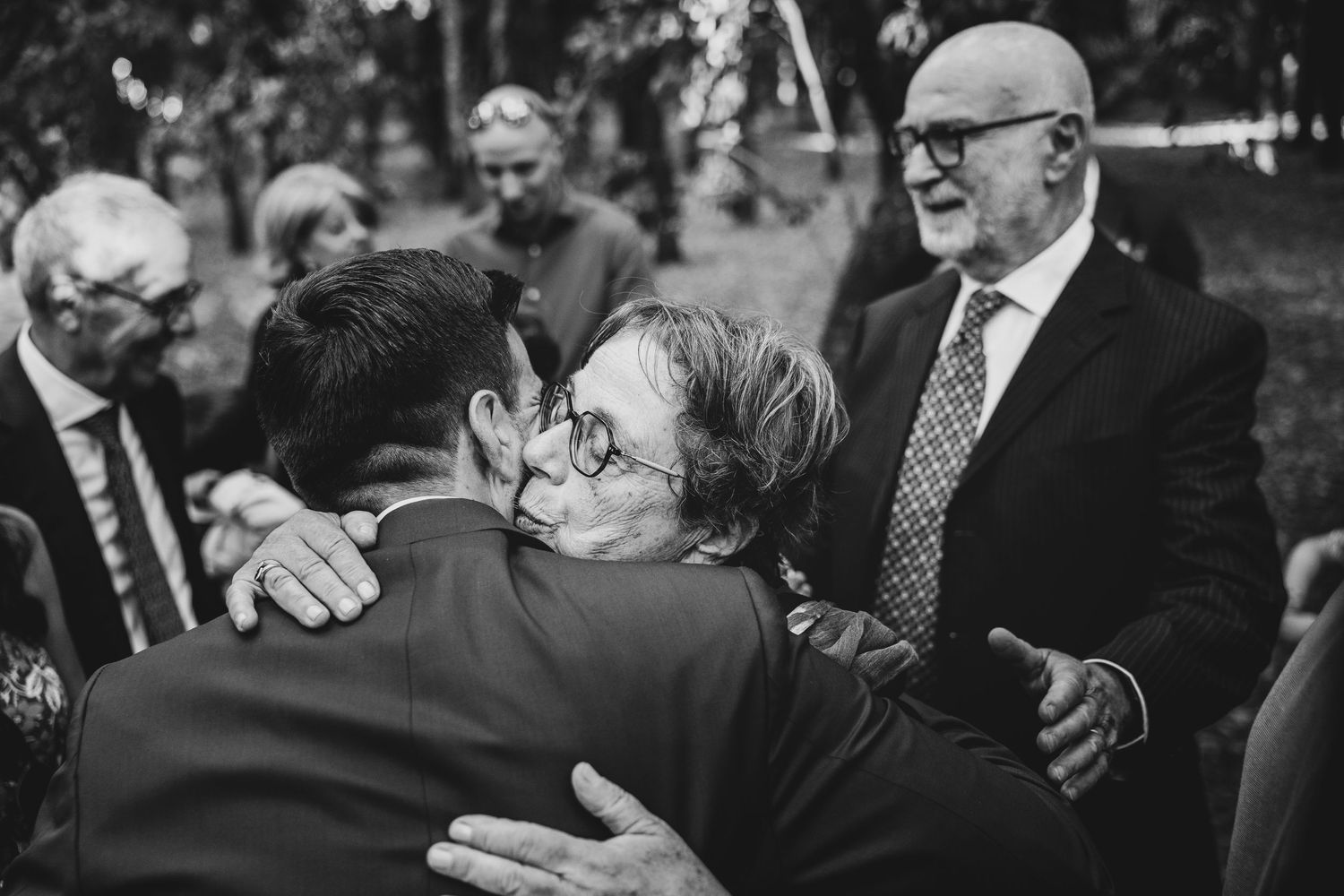 Wedding guests share joyful moments during an outdoor celebration.