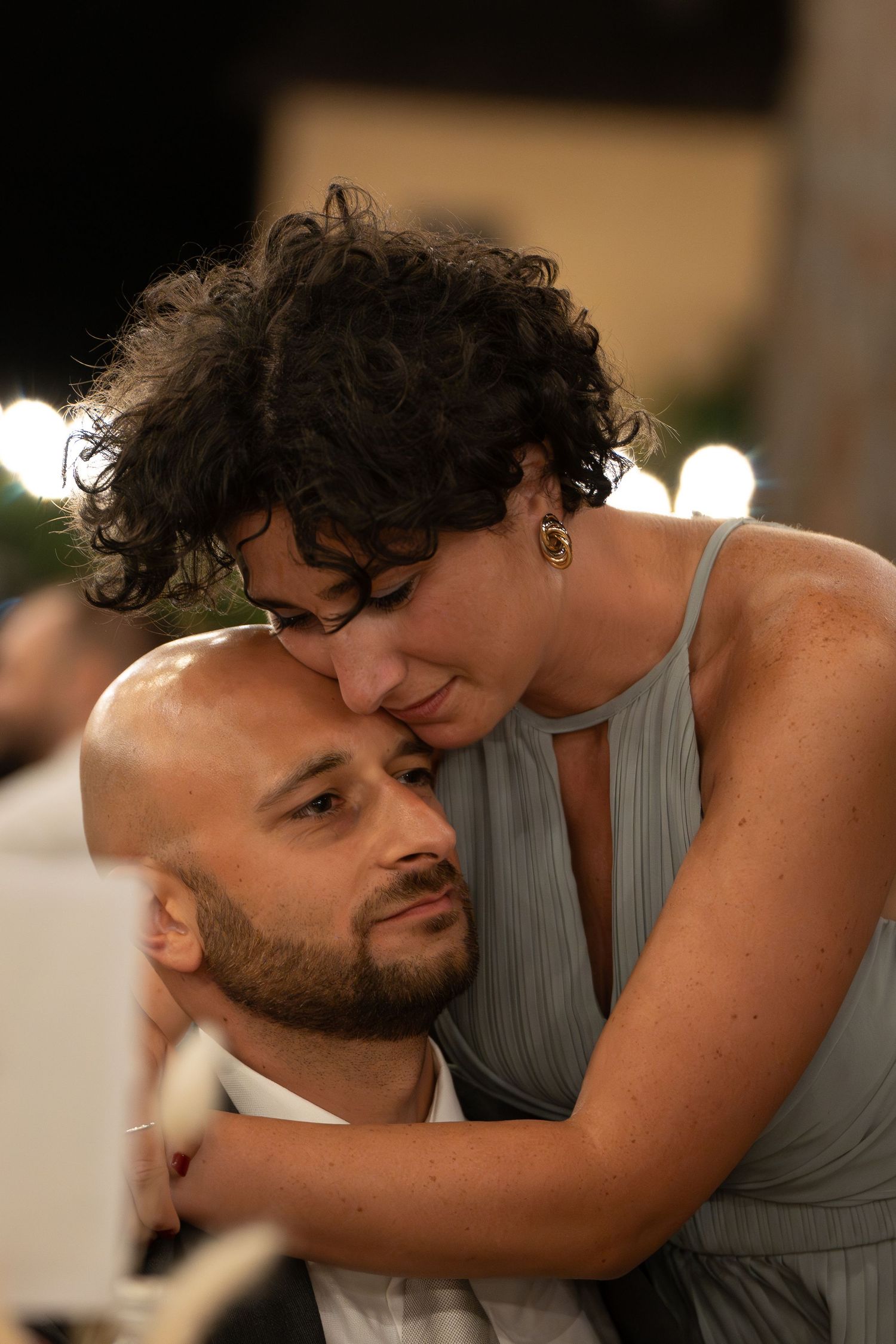 Intimate dance moment between wedding guests at a reception.
