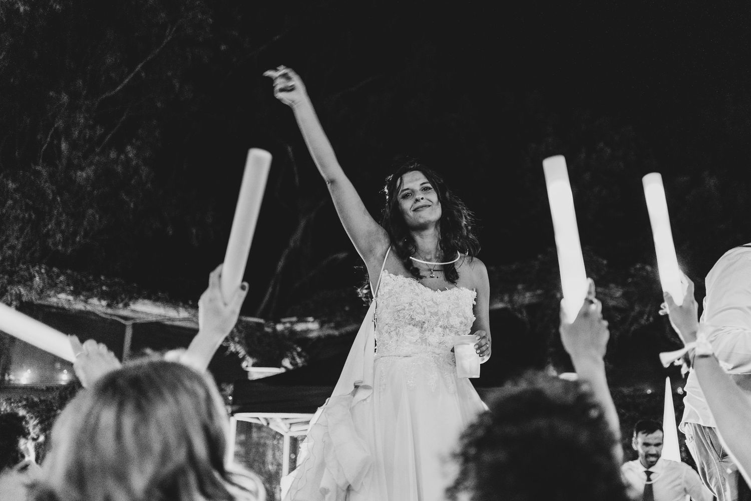 A series of black and white photos capturing joyful dancing and celebration moments at a wedding reception.