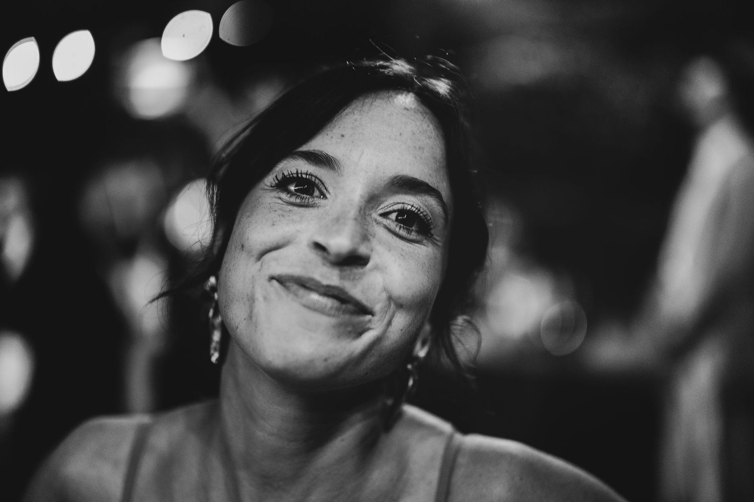 A black and white close-up portrait of someone looking upward with a contemplative expression.