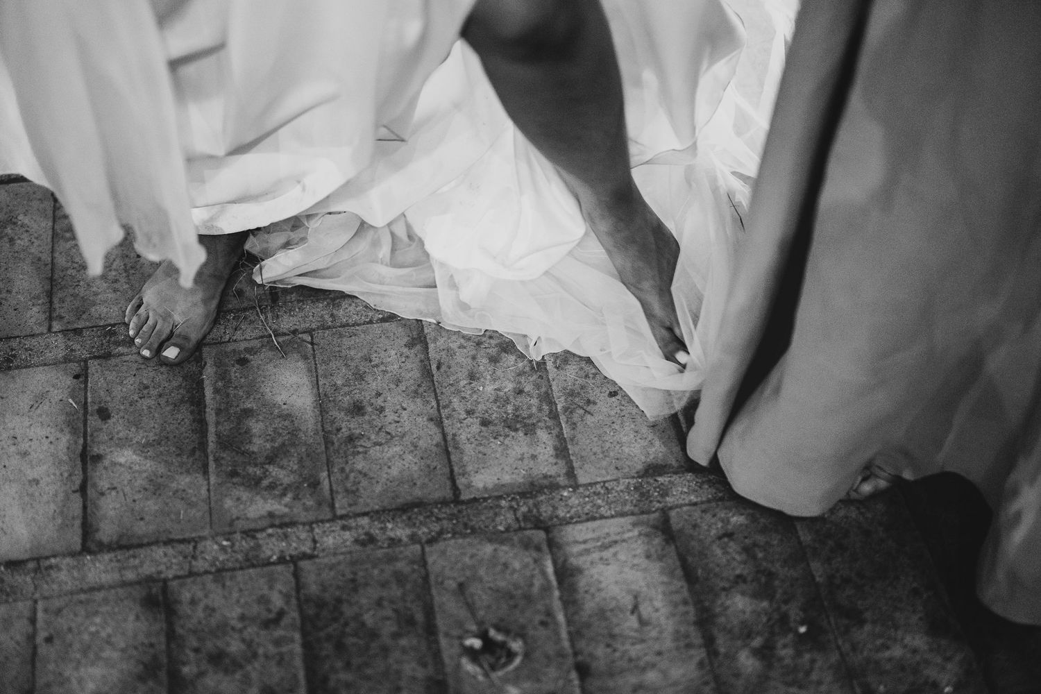 Black and white photographs show a person's feet walking across a wooden floor in sequence.