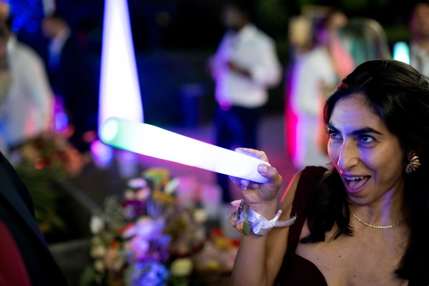 Guests enjoying themselves on a dimly lit dance floor with blue lighting effects.